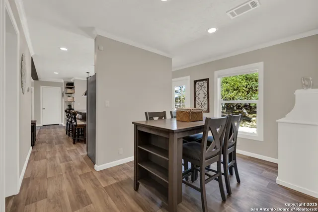 a view of a dining room with furniture and a window