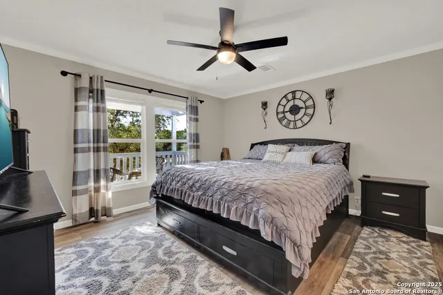 a bedroom with a bed and a flat tv screen on the dresser