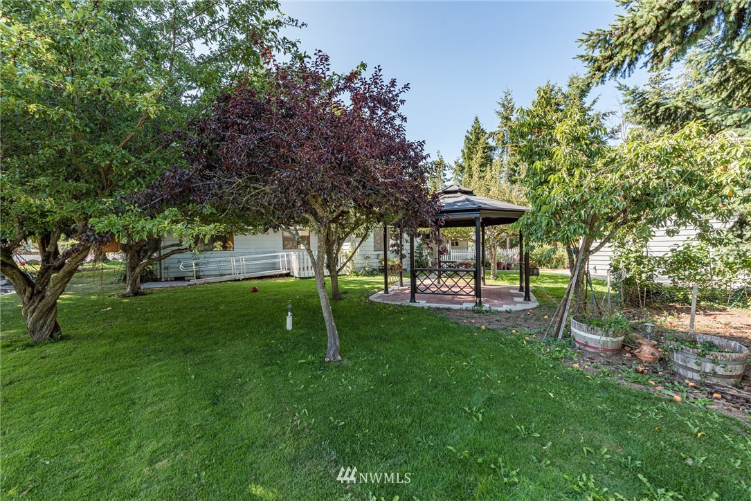 281 Wright Road Sequim, WA 98382 - Photo 16 of 25 a view of a park with a bench and trees