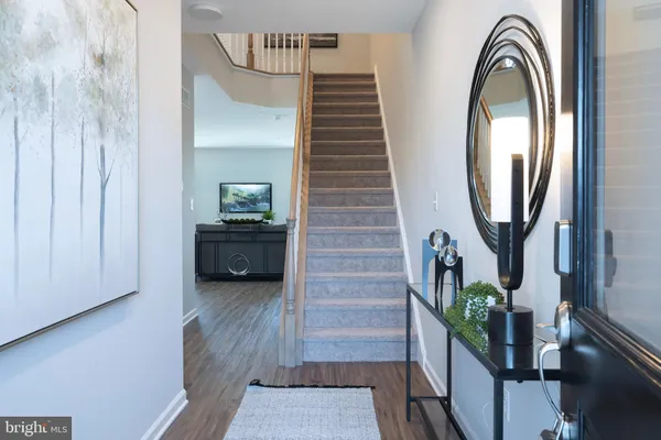 a view of a hallway with entryway wooden floor and front door
