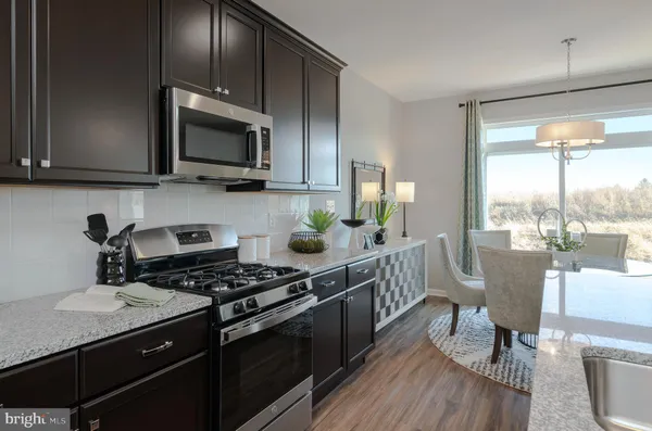 a kitchen with a stove a sink and a microwave