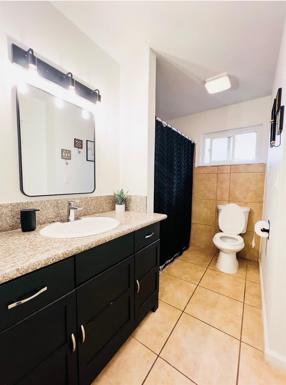 2101 Milford Lane Modesto, CA 95355 - Photo 11 of 18 a bathroom with a sink and a mirror