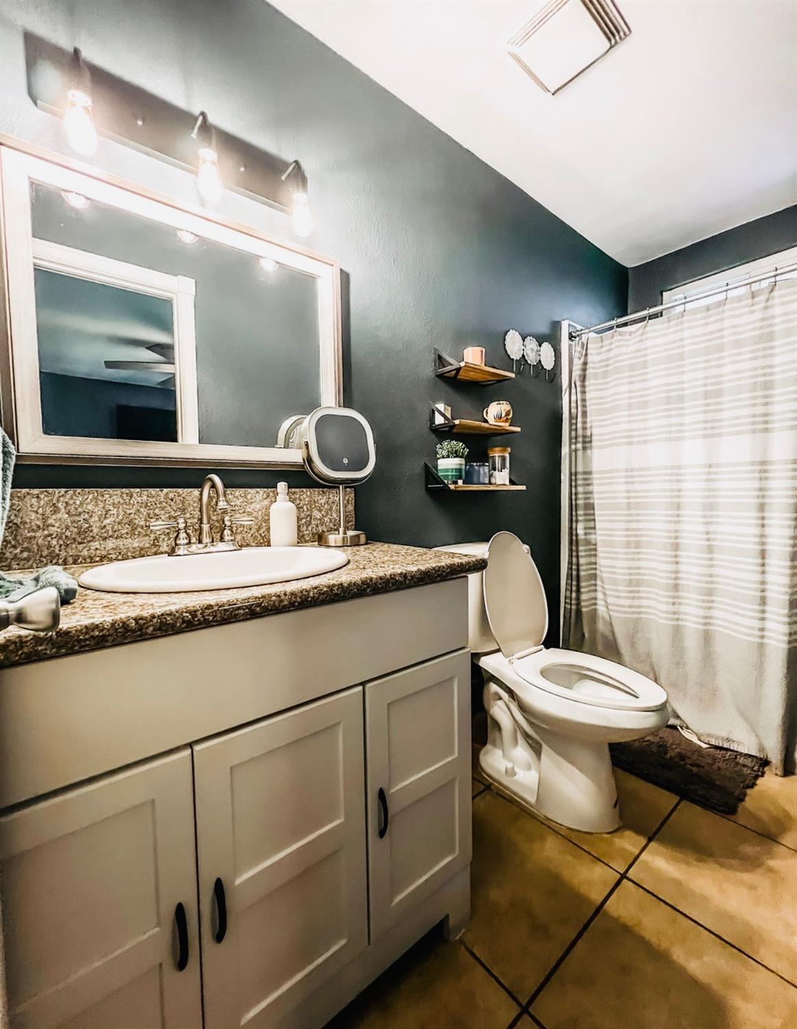2101 Milford Lane Modesto, CA 95355 - Photo 12 of 18 a bathroom with a sink toilet and shower
