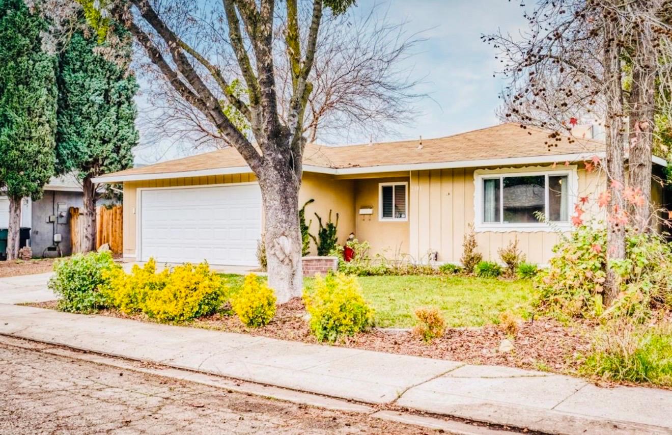 2101 Milford Lane Modesto, CA 95355 - Photo 3 of 18 a front view of a house with a yard and garage