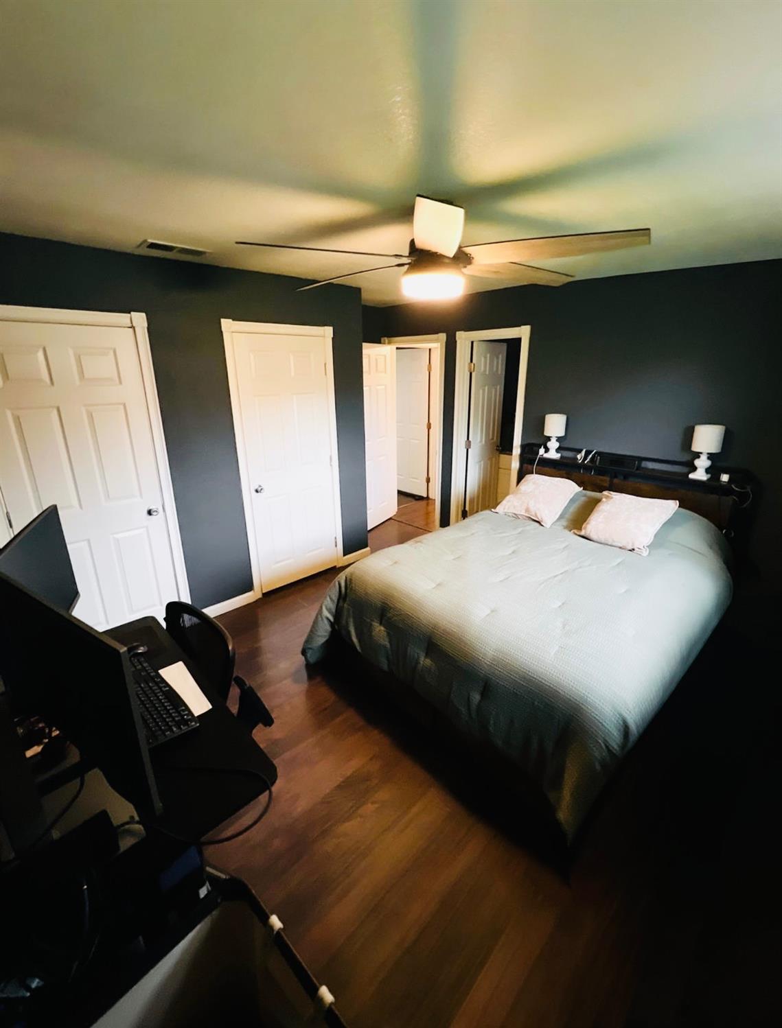 2101 Milford Lane Modesto, CA 95355 - Photo 10 of 18 a bedroom with a bed and a chandelier