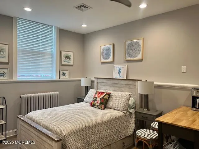 a bedroom with a bed and a table with chair