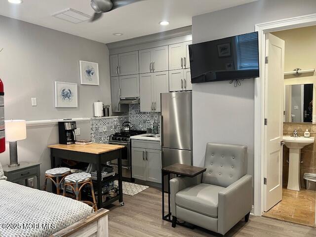 892 Elberon Avenue, Unit STUDIO Elberon, NJ 07740 - Photo 12 of 24 a dining room with stainless steel appliances kitchen island granite countertop a refrigerator a stove a sink dishwasher a dining table and chairs with wooden floor