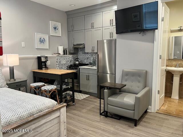 892 Elberon Avenue, Unit STUDIO Elberon, NJ 07740 - Photo 10 of 24 a kitchen with stainless steel appliances kitchen island granite countertop a refrigerator a stove a sink dishwasher and white cabinets with wooden floor