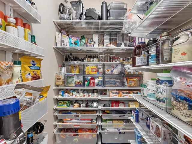 a shelf of wine sitting in a kitchen