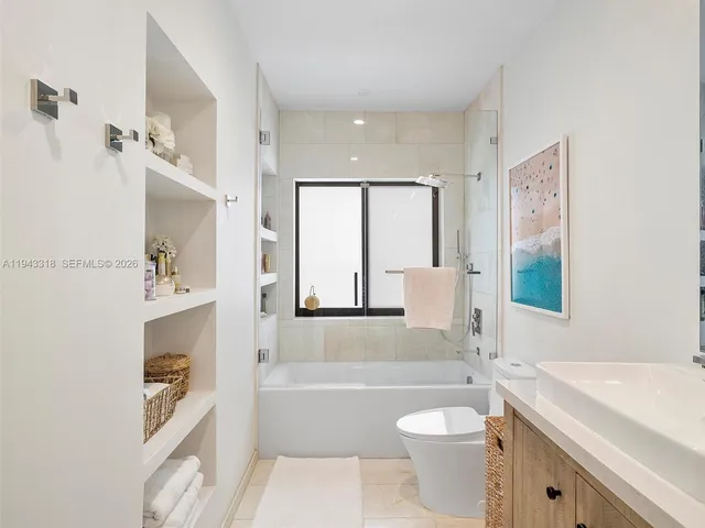 a bathroom with a granite countertop toilet a sink and a bathtub