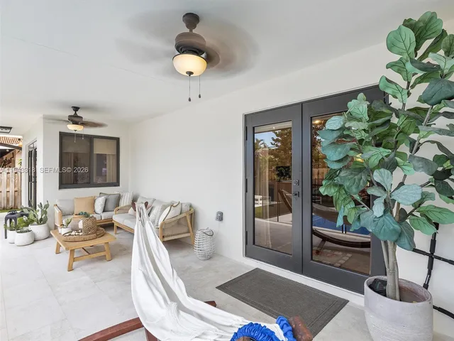 a living room with furniture and a potted plant