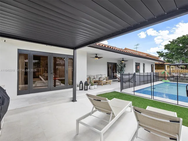 a view of a house with backyard porch and sitting area