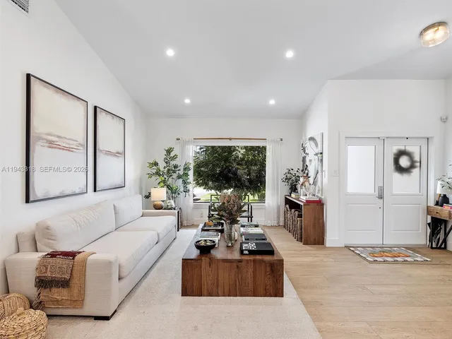 a living room with furniture large window and flat screen tv