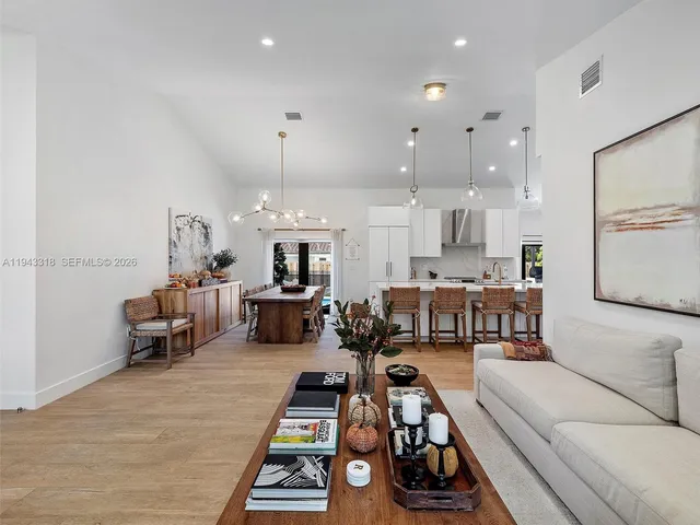 a living room with furniture a table and chairs