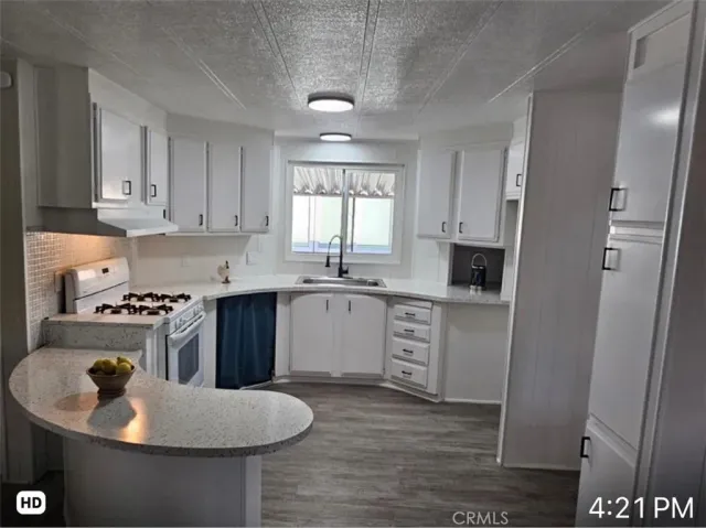 a kitchen with a sink stove and refrigerator