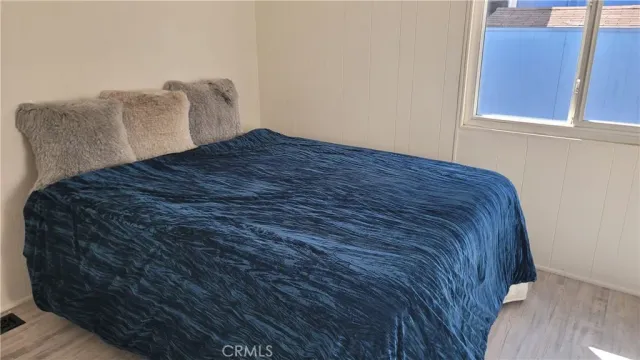 a bed sitting in a bedroom next to a window
