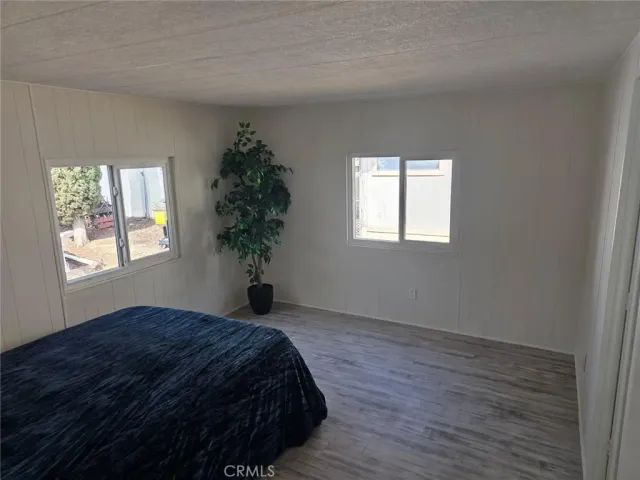 a bed sitting in a bedroom next to a window