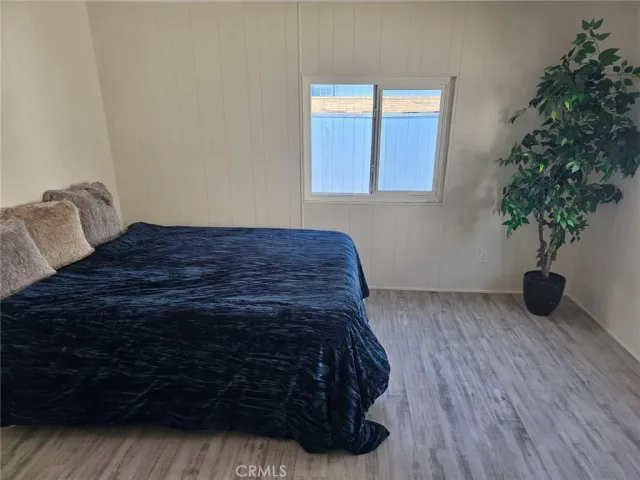 a bedroom with a bed window and potted plant