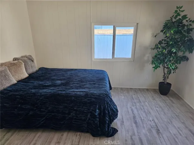 a bedroom with a bed and a potted plant
