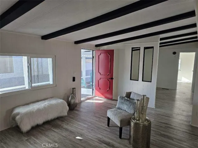 a bedroom with furniture and wooden floor