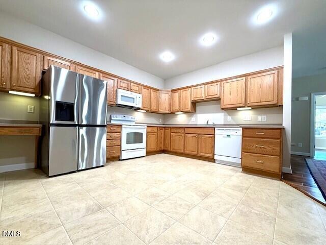 4713 Ivy Crest Court Raleigh, NC 27604 - Photo 27 of 46 a kitchen with stainless steel appliances granite countertop a refrigerator and wooden cabinets