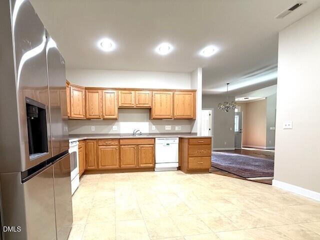4713 Ivy Crest Court Raleigh, NC 27604 - Photo 29 of 46 a large kitchen with a refrigerator a stove top oven a sink and dishwasher