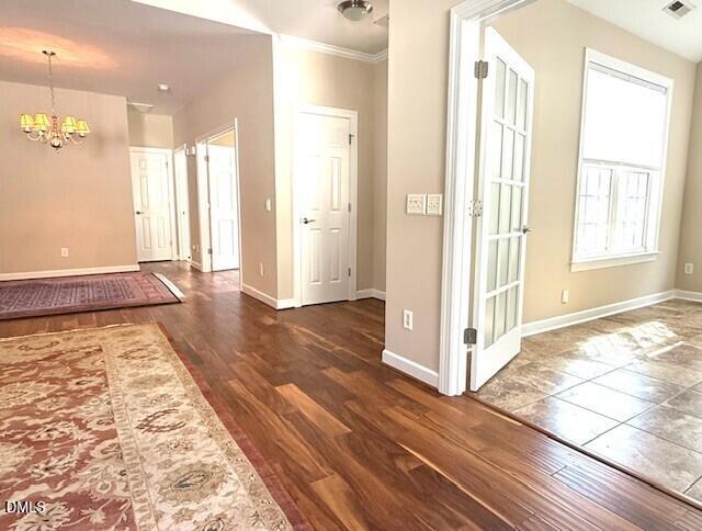 4713 Ivy Crest Court Raleigh, NC 27604 - Photo 4 of 46 a view of a hallway with wooden floor and a bathroom