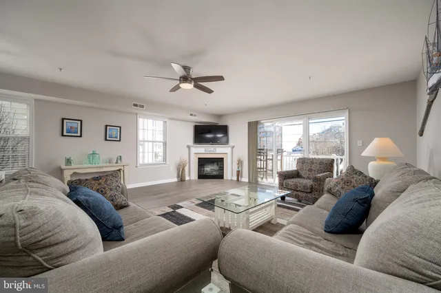 a living room with furniture fireplace and a window