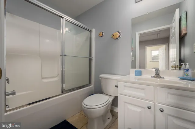 a bathroom with a toilet a sink and a mirror