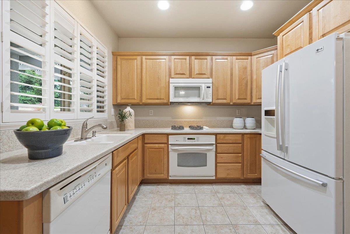 286 Lariat Loop Lincoln, CA 95648 - Photo 11 of 37 a kitchen with stainless steel appliances a stove a sink a refrigerator a microwave and cabinets