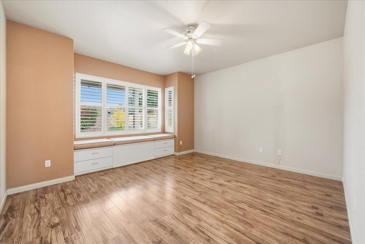 286 Lariat Loop Lincoln, CA 95648 - Photo 12 of 37 a view of an empty room with wooden floor and a window