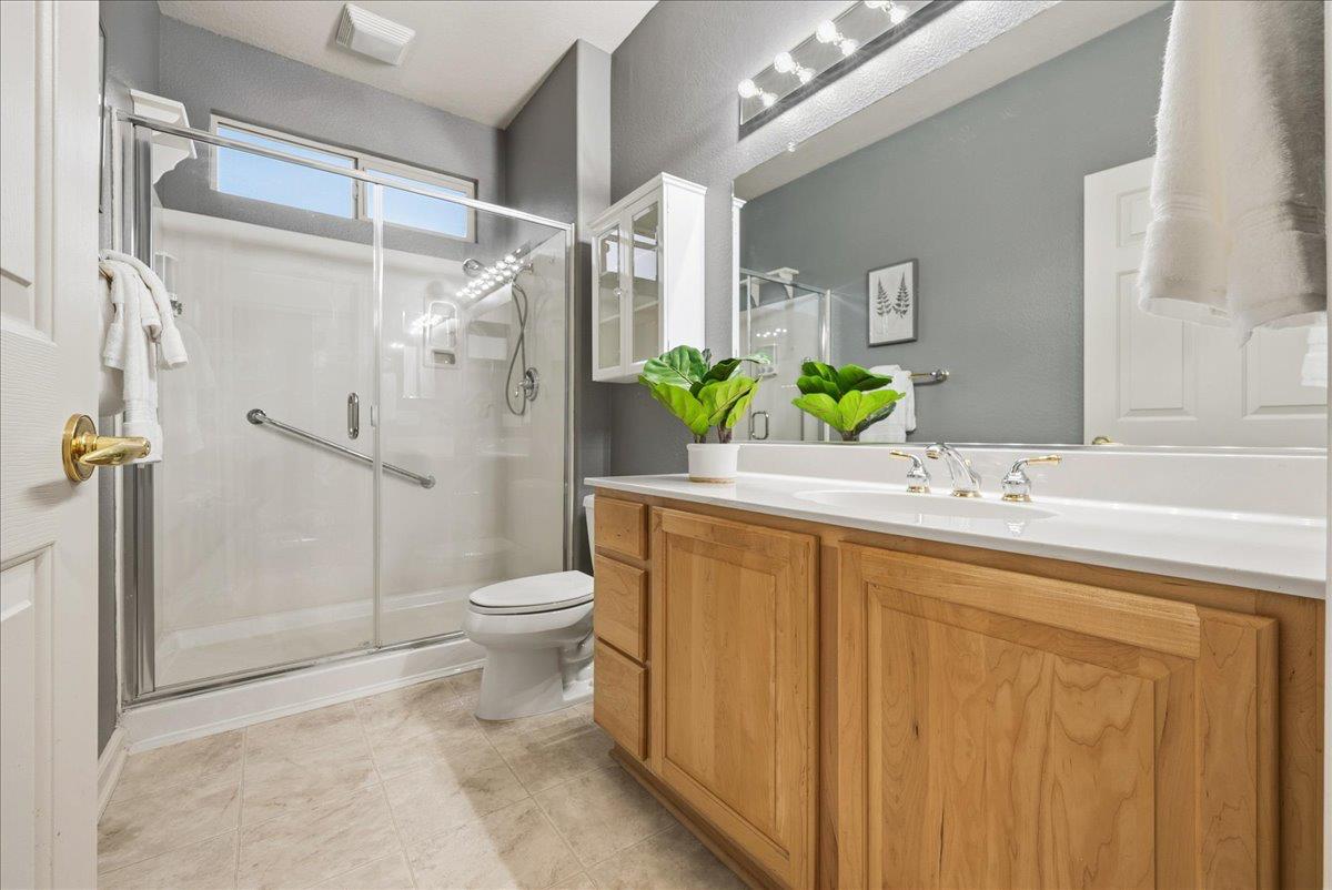 286 Lariat Loop Lincoln, CA 95648 - Photo 14 of 37 a bathroom with a granite countertop sink toilet and shower