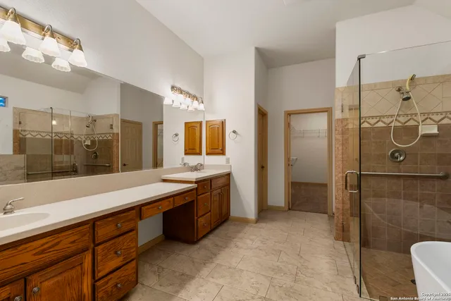 a spacious bathroom with a granite countertop sink mirror and shower