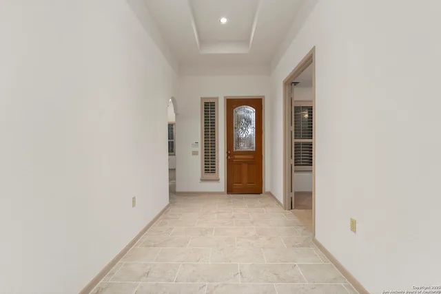 an empty room with closet and windows