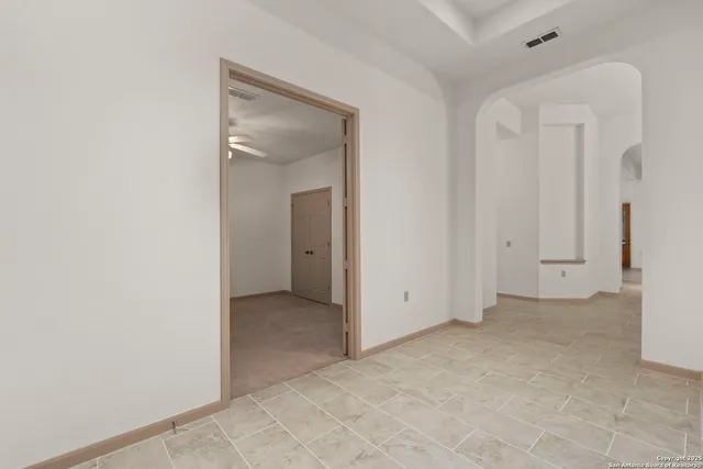 an empty room with closet and a bathroom