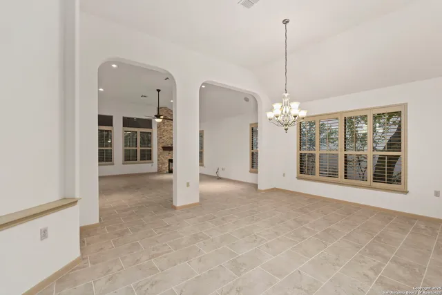 a view of a room with a large window and chandelier
