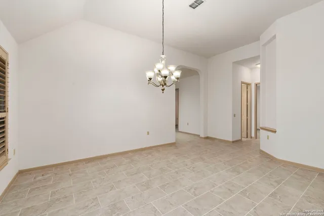 a view of a chandelier in big room and chandelier