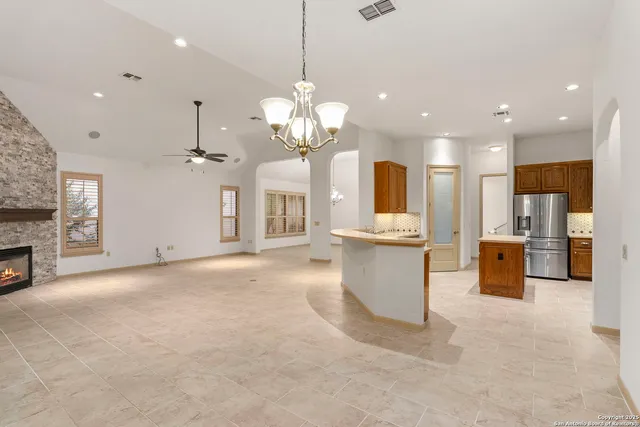 a view of a kitchen with granite countertop cabinets and a fireplace