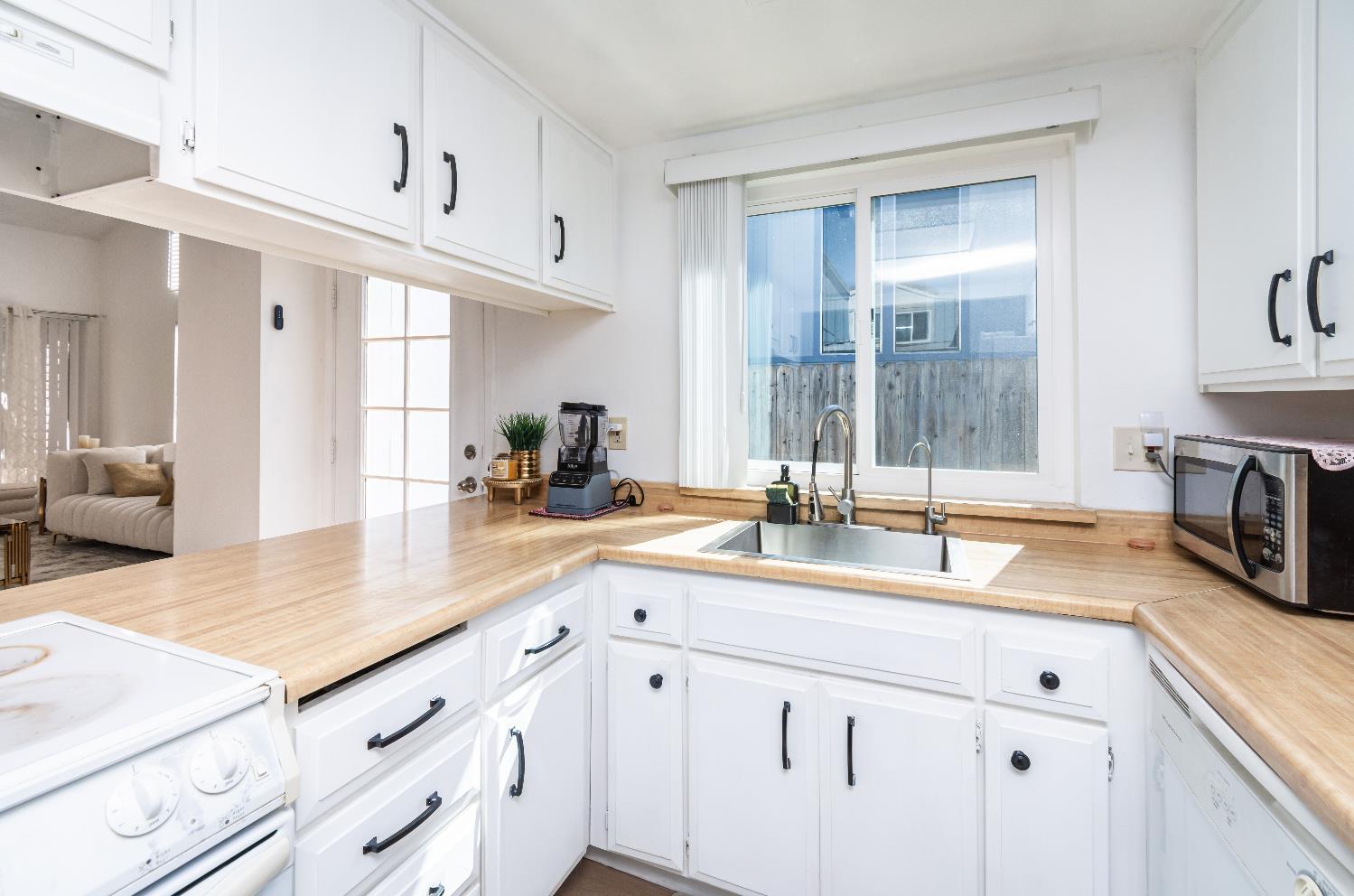 2000 Inglis Way, Unit A Roseville, CA 95678 - Photo 15 of 45 a kitchen with granite countertop a sink and white cabinets