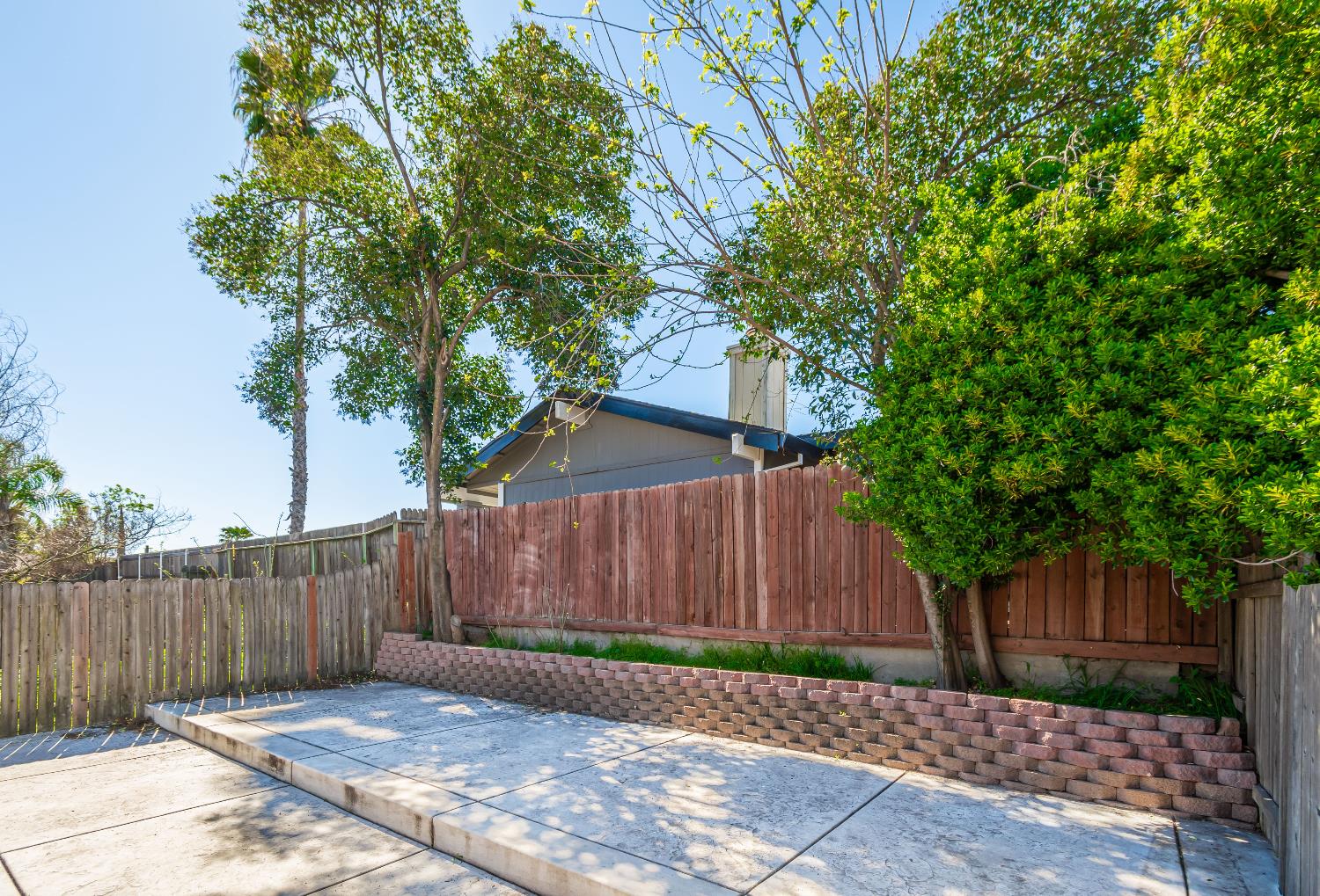 2000 Inglis Way, Unit A Roseville, CA 95678 - Photo 35 of 45 a wooden fence with trees in front of it