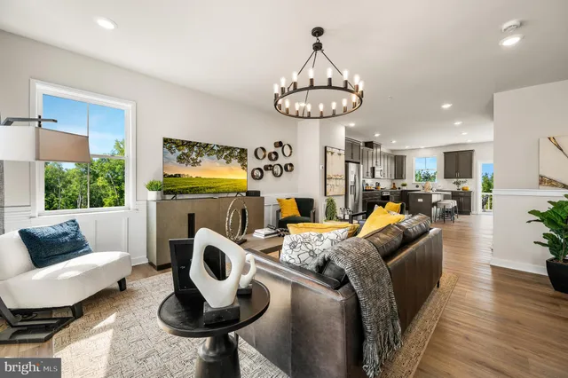 a living room with furniture and a chandelier
