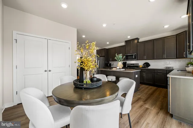 a kitchen with a table chairs and a refrigerator