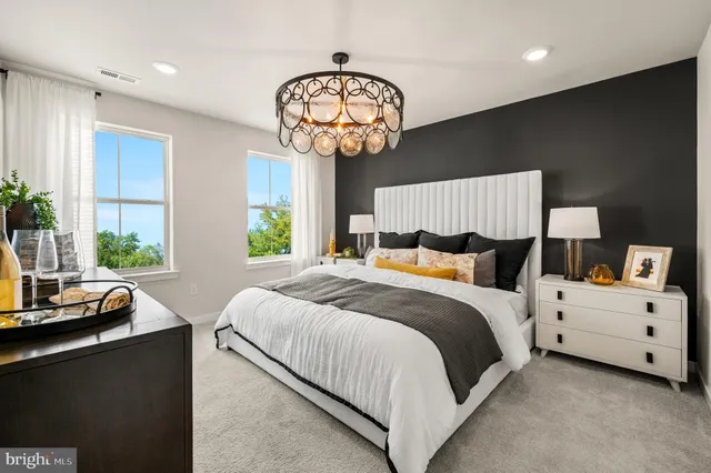 a bedroom with bed and a large window