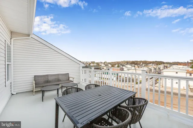 a terrace of a house with outdoor seating