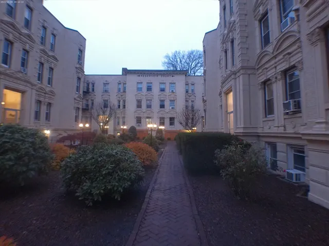 a view of a building with brick walls and plants