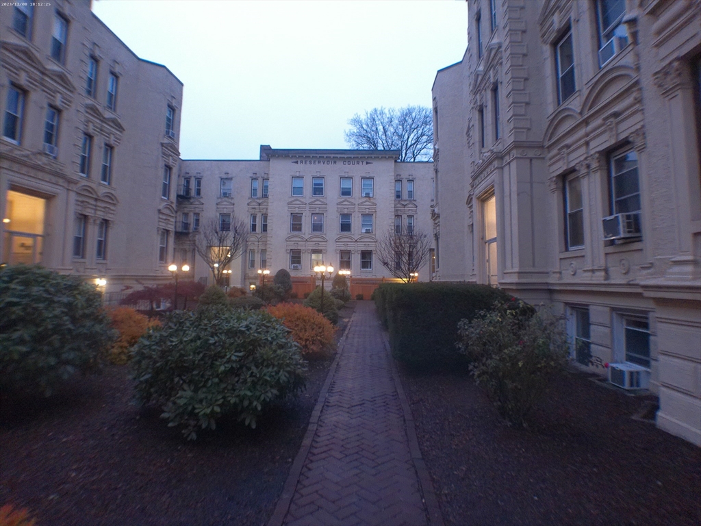 a view of a building with brick walls and plants