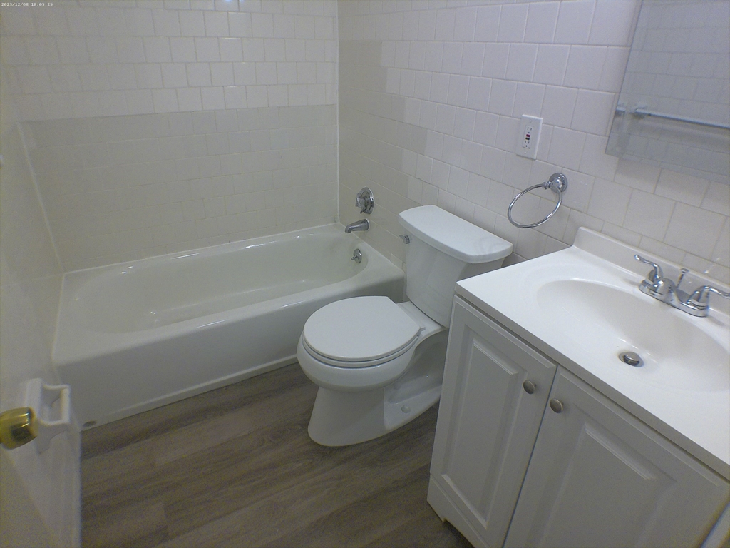1862 Beacon Street, Unit 1B3 Brookline, MA 02445 - Photo 17 of 23 a bathroom with a sink toilet and shower