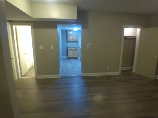 a view of a hallway with wooden floor