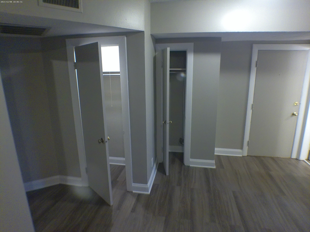 1862 Beacon Street, Unit 1B3 Brookline, MA 02445 - Photo 9 of 23 an empty room with wooden floor and closet