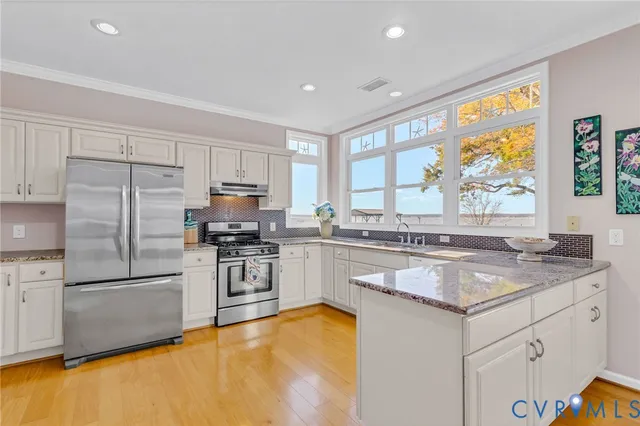 a kitchen with a refrigerator a stove a sink and a counter space